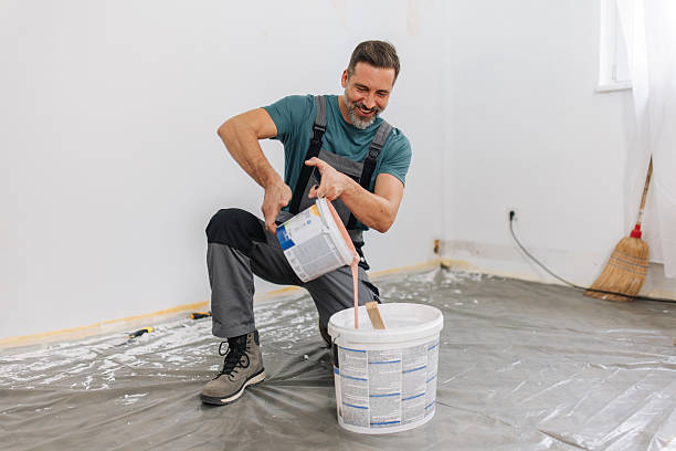 istock Man Engaged in Mixing Paint for A Room Project 2245120858