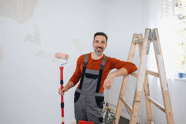 istock Smiling Man Dressed for Painting in Creative Space 2245121564