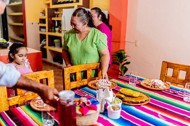 istock Family setting the table at home 2245126083
