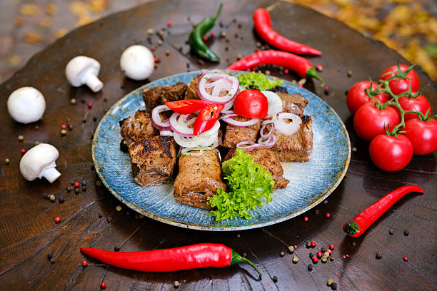Meat set for a large group. A dish of different types of meat: beef steak, pork cuts and ribs, chicken kebab and grilled quail, lamb ribs. Menu for a pub on a dark background.