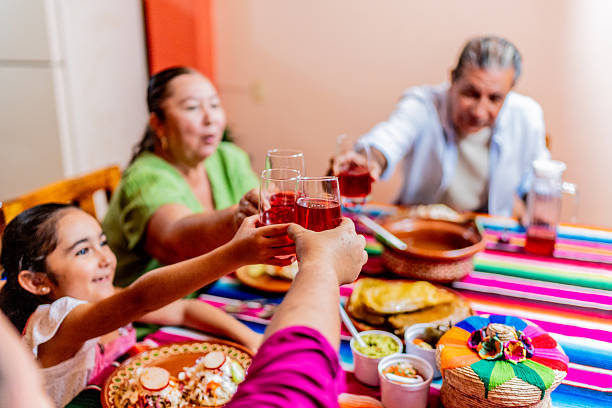 istock Family toasting drinks during lunch at home 2245126196