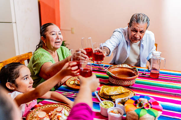 istock Family talking and toasting drinks during lunch at home 2245126200