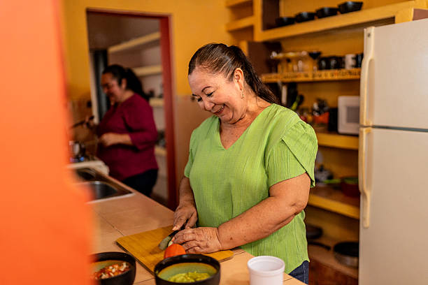 istock Senior woman cooking at home 2245127440