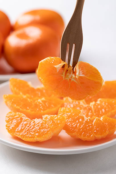 istock Fresh cut of Mandarin orange fruit on plate ready to eating 2245127441