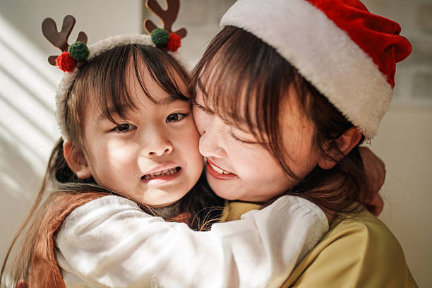istock Mother and Daughter Hugging During Christmas Celebration 2245127588