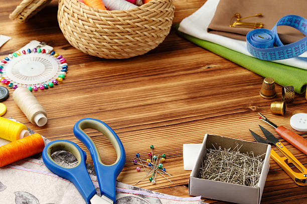 istock Crafting tools and materials arranged on a wooden table for sewing projects 2245127995