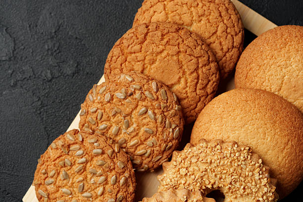 istock Freshly baked cookies arranged on a wooden tray in a cozy kitchen setting 2245128011