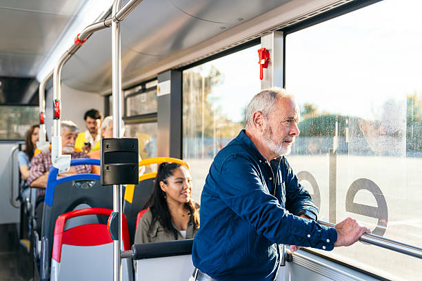 istock Senior man riding public city bus looking out window 2245129941