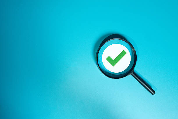 istock Magnifying glass focusing on a green checkmark icon, symbolizing quality control (QC), verification, approval, and success. 2245131702