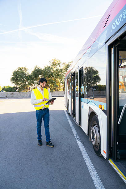 istock Inspector checking electric city bus with tablet 2245133147