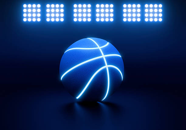 istock Blue basketball with bright blue glowing neon lines in under illuminated floodlights 2245133151