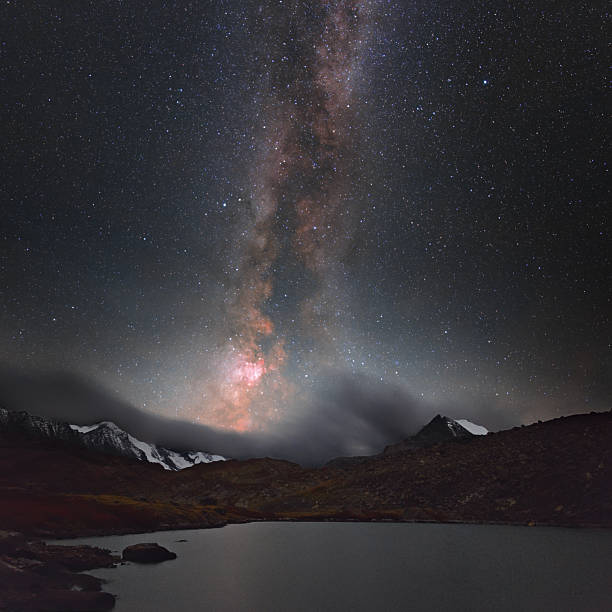 istock Milky Way over mountain peaks and lake. 2245133374