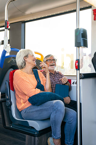 istock Happy senior couple riding public bus enjoying technology 2245133517