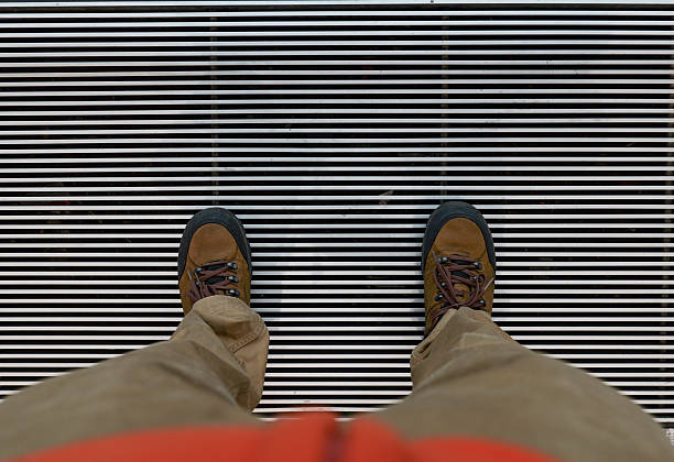Men Stand on the Metal Grate