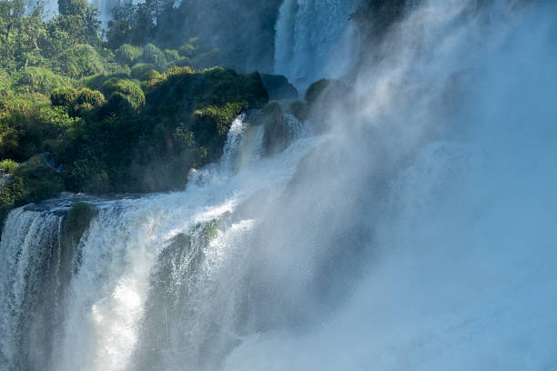 Iguacu Falls in Brazil in the foreground and Argentina seen beyond the river