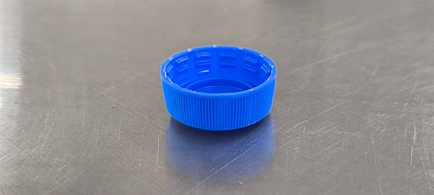 istock Blue soda bottle caps on a stainless steel table 2245138380