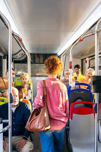 istock Diverse passengers traveling by public city bus 2245138384