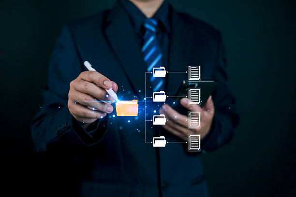 istock Businessman using digital pen and smartphone to manage online document files with virtual folder structure, cloud data storage, and smart business management technology concept. 2245138799