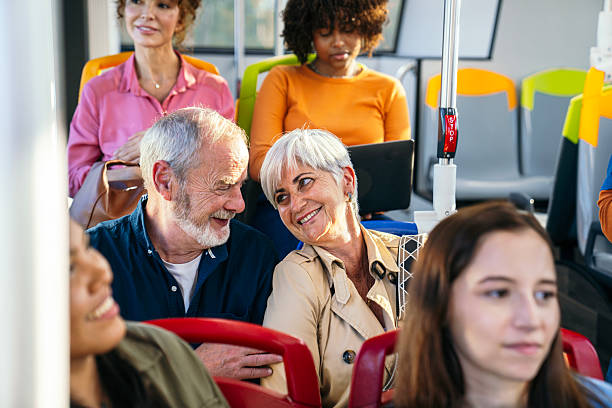istock Senior couple smiling during public transport trip 2245138996