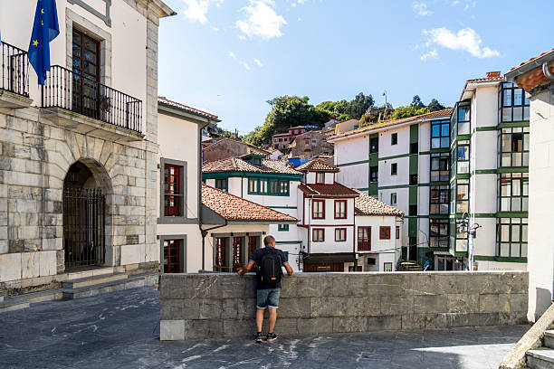 A man walks through the center of the village of Cudillero, Asturias, Spain.