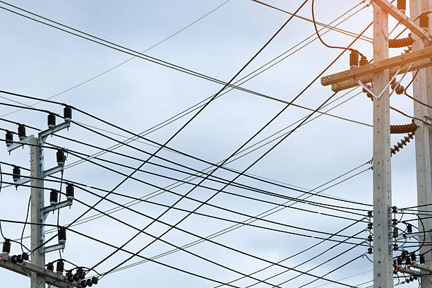 istock This image captures a chaotic tangle of black electric wires and communication cables overloading a concrete utility pole, symbolizing urban complexity and aging infrastructure. 2245140606