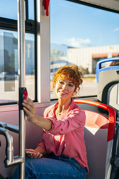 istock Woman paying for public bus transport using an nfc device 2245141205