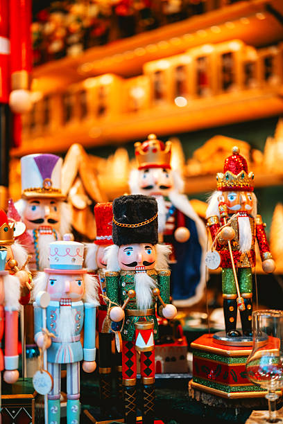 istock Collection of festive nutcracker figures with crowns and drums in warm illuminated market display 2245148568
