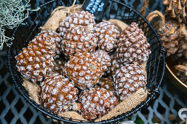 istock Natural pine cones dusted with white material sit in a woven basket ready for decoration. 2245148700