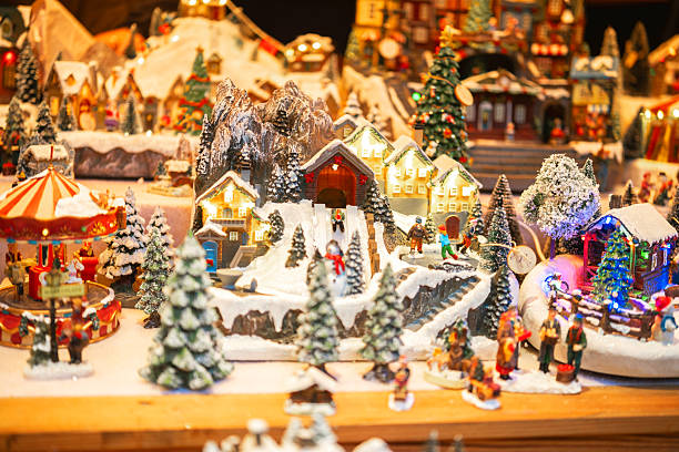 istock Winter village scene with carousel and small figures engaged in activities 2245148957