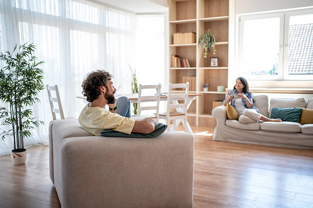 istock Happy couple relaxing at home enjoying leisure time 2245149885
