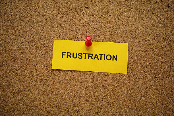 istock A yellow paper note with the word Frustration on it pinned to a cork board. 2245152994