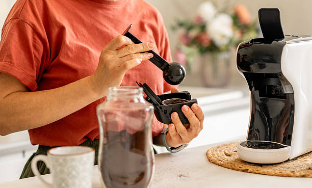 istock Woman Making Coffee In Coffee Machine 2245153065