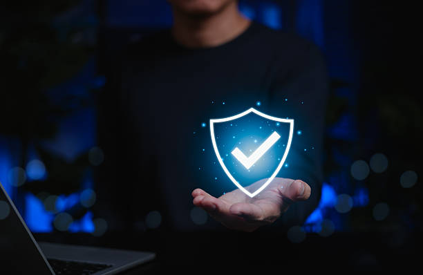 istock Person holding glowing digital shield with check mark icon representing online security, safety, cybersecurity assurance, insurance, trust, data protection, authentication, verified system, compliance 2245153192