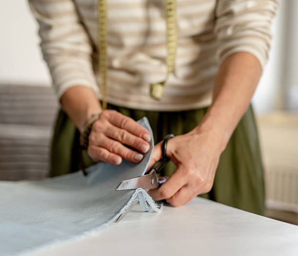 istock Woman Cutting Fabric With Tailor Scissors 2245153466