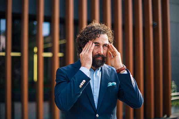 istock Stressed businessman suffering from headache and occupational burnout 2245153725