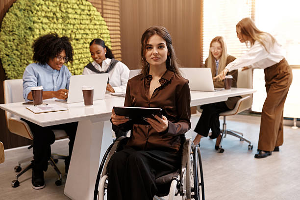 istock Confident disabled woman using tablet in inclusive modern office 2245154510