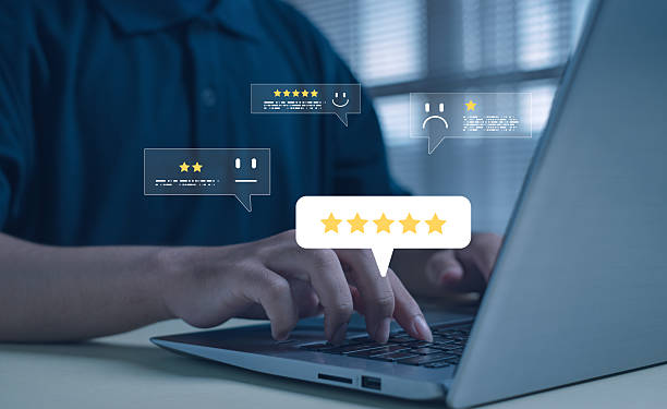 istock Online customer feedback concept showing hands typing on laptop with floating five-star rating icons, symbolizing user reviews, digital reputation, customer satisfaction, and business service quality. 2245154531