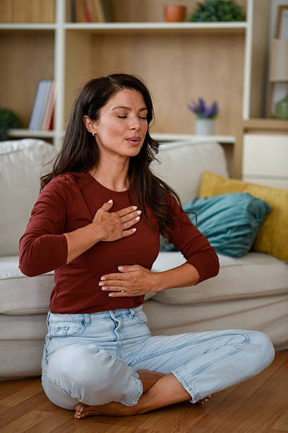 istock Woman doing breathing exercises at home 2245156642