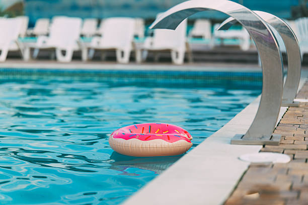istock Donut float in a swimming pool on a sunny day 2245158479