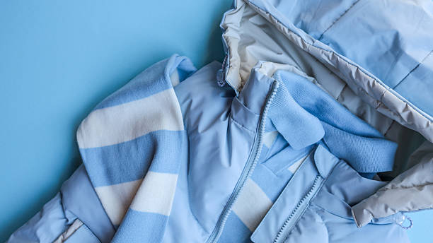 istock Baby blue winter clothing set on a light blue background, top view. 2245158645