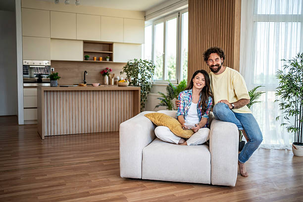 istock Happy couple relaxing together in modern home 2245159635