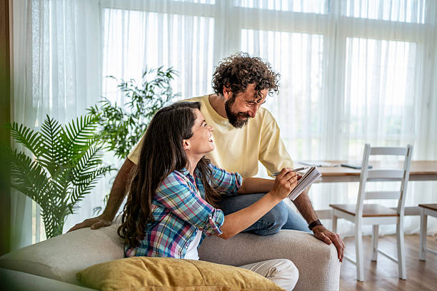 istock Happy couple writing in notebook on sofa 2245159696