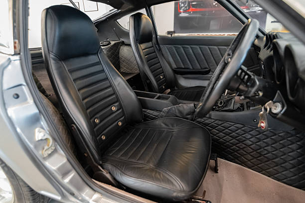 Vilnius, Lithuania - April 11, 2023: A true JDM Datsun Fairlady Z (240Z). Car after full restoration, painted in elegant grey colour. Interior view, fully reupholstered in black leather. Custom retrimm of door panels, gearbox tunnel. RHD original JDM model.