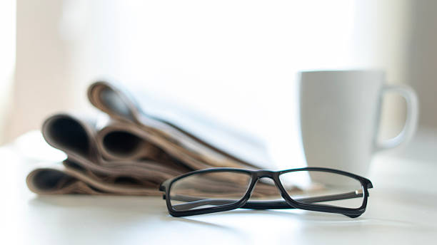 istock newspaper and eyeglasses at office desk 2245159886