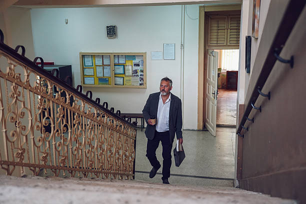 istock Middle-aged professor on university stairs 2245162400