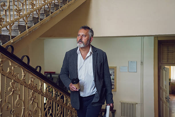 istock Middle-aged professor on university stairs 2245162463