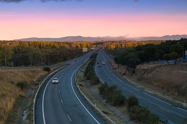 istock Scenic view of empty highways at sunset with distant mountains in the background 2245162581