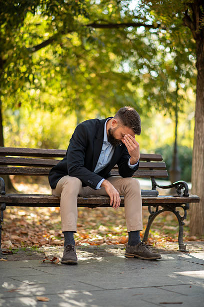 istock Worried man lost in thought outdoors 2245166112