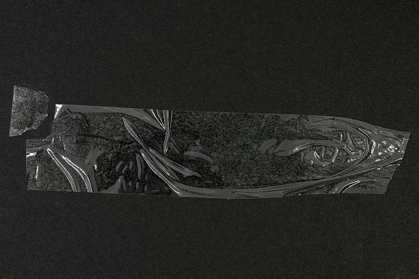 istock Transparent plastic adhesive tape on black background 2245166260