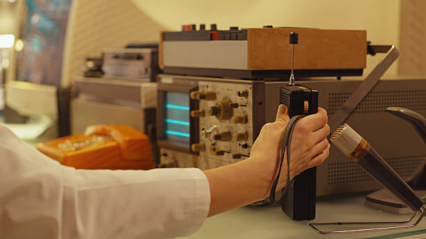 Retro medical research laboratory. Oscilloscope and other old technology being used to conduct research. Team of scientists working to collect data